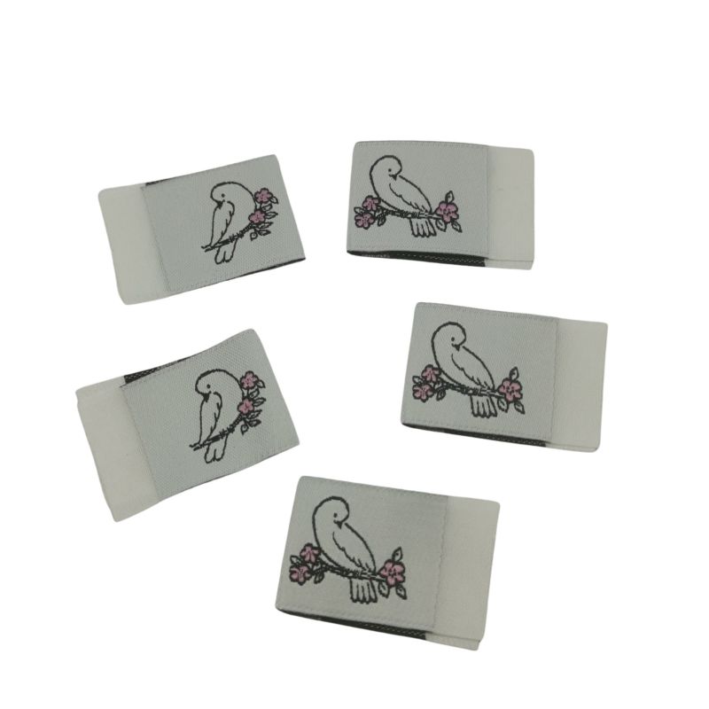 Weblabel zum einnähen mit Annähkante Vogel auf Ast 20 x 30mm